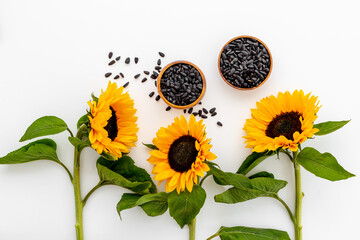 Fototapeta premium Yellow sunflowers with black seeds. Top view. Harvest season background
