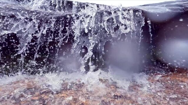 Water drops from a small stream waterfall, clear glacier water in Norway Eikerapen, Aseral municipality in Agder county