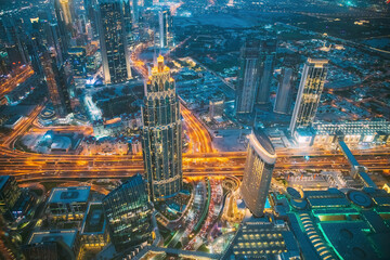 Aerial View Of Street Night Yellow Illumination Of Traffic In Residential District In Dubai. City Night Scenic View Of Skyscraper In Dubai. Urban background of Dubai, UAE, United Arab Emirates. High