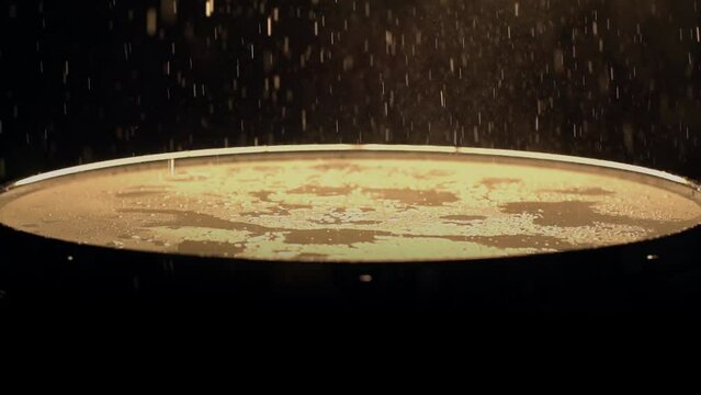 A slow motion of water droplets falling on a drum