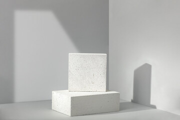 Minimalism pedestal on gray background and wall with shadows. 