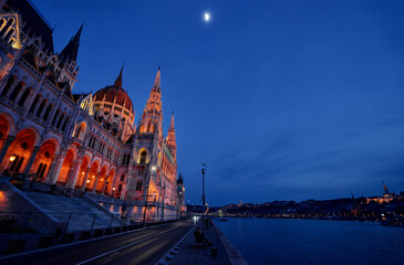 The Hungarian Parliament Building on the bank of the Danube in Budapest at night time.
