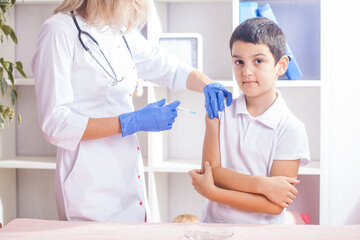 vaccination of children, a little boy at a doctor's appointment, an injection in the arm