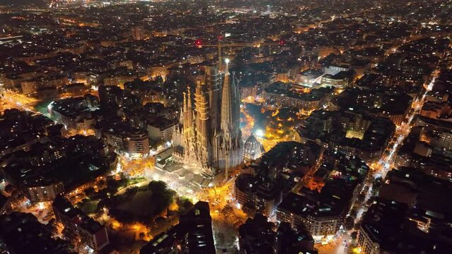 Temple Expiatori La Sagrada Familia in Barcelona, Catalonia, Spain. Flying around the architectural masterpiece of Gaudi in the nighte, UHD, 4K