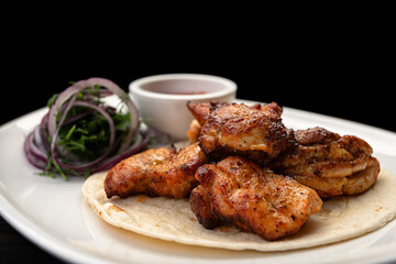 Pork kebab with barbecue sauce on a plate, with a small depth of field