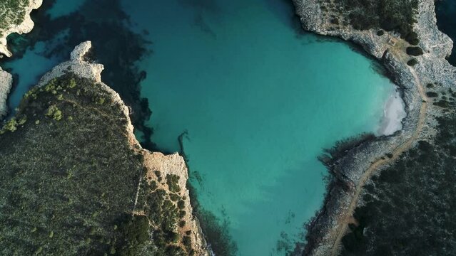 Aerial drone footage captured in Mallorca island during sunset time. Island located in Mediterranean sea and belongs to Balearic Islands. The coast line you see in footage is called Cala Varques.