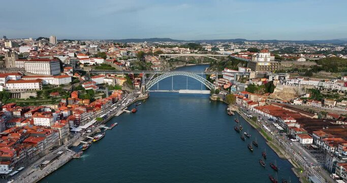 Aerial view of Porto city in Portugal. Cityscape of downtown touristic Ribeira, old town, Douro river and Dom Luis I bridge during the sunny evening.