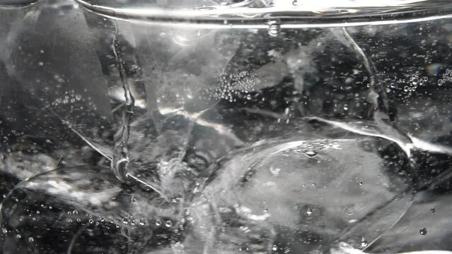 Soda with ice and bubbles. Sparkling cold soft drink, carbonated liquid and cool iced tonic in a glasses. Soda fizzy drink frozen cubes in transparent glass macro view. Refreshing beverages concept.