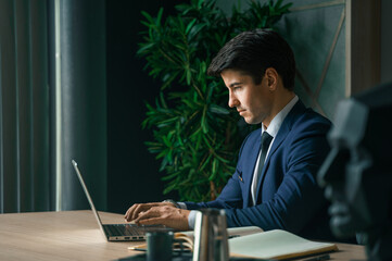 Businessman working with laptop in modern office. General manager,ceo. Young handsome confident man...
