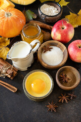 Autumn baking food background with pumpkins, apples, honey, nuts and seasonal spices on a stone table. Pumpkin or apple pie for Thanksgiving and autumn holidays. Copy space.