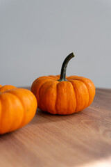 ripe red pumpkins on a wooden background close-up with a blurred background. autumn mood.