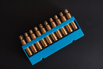 Amber gold empty bullet cases in blue holder