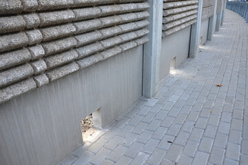 freeway bridge drainage. A sound-absorbing wall with holes lets water through. gutters collect...