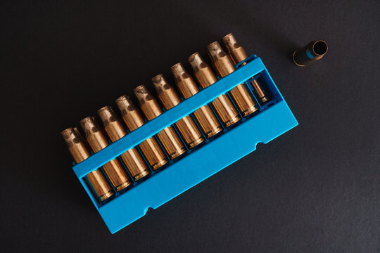 Amber Gold Empty Bullet Cases In Blue Holder