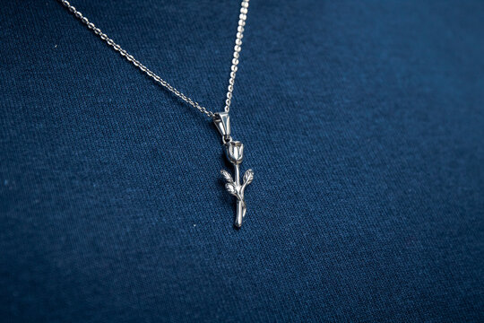 Silver necklace on blue background jewelry fashion 