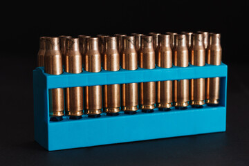 Amber gold empty bullet cases in blue holder