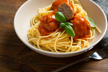 Close up of tasty spaghetti with meat balls tomato sauce on wood table selective focus italian food