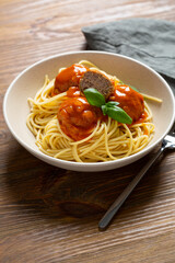Close up of tasty spaghetti with meat balls tomato sauce on wood table selective focus food