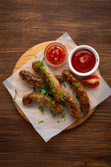 Top view of lamb beef grilled sausages chopped greens smoked food and dips on wood