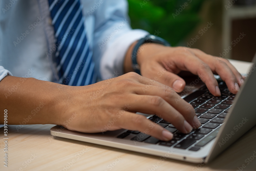 Poster male hands typing on keyboard laptop at the office.search information form internet working on compu