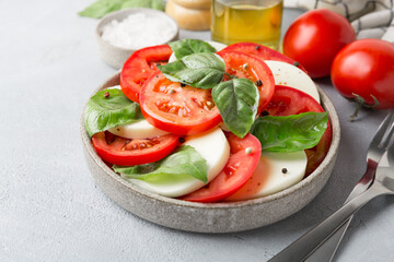 Caprese Salad with tomatoes and mozzarella with olive oil.