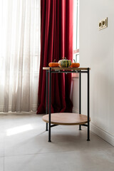 ripe pumpkins in the interior. preparation for halloween. room interior with table and window.