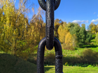 black chain in the park on a blurry background.