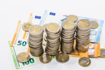 The pile of euro coins on euro notes. Business and financial growth and improvement concept