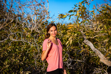 portrait of a beautiful woman making her way through dense mangroves in francois peron national...
