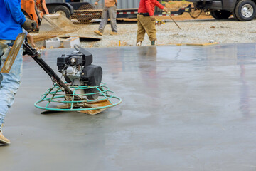 Process polishing and leveling cement screed mortar floors on construction site in process...