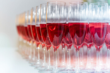 A lot of pink champagne glasses arranged on the table