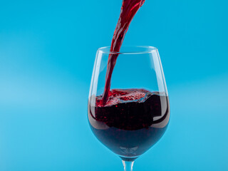 A glass of wine on a blue background.