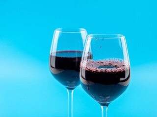A glass of wine on a blue background.