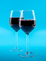 A glass of wine on a blue background.