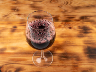 Glass of wine on a wooden background.
