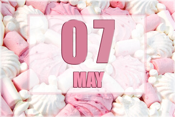 calendar date on the background of white and pink marshmallows.  May 7 is the seventh day of the month