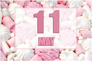calendar date on the background of white and pink marshmallows. May 11 is the eleventh  day of the month