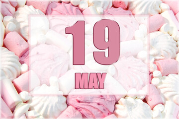 calendar date on the background of white and pink marshmallows. May 19 is the twenty-second day of the month