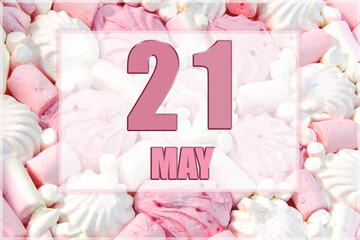calendar date on the background of white and pink marshmallows. May 21 is the twenty first day of the month