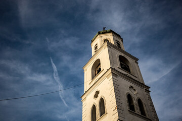 Fototapeta na wymiar Low angle view of the church bell tower, Samokov, Bulgaria. Dramatic sky in the background