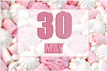 calendar date on the background of white and pink marshmallows. May 30 is the thirtieth day of the month