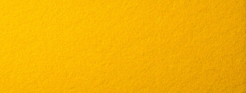 黄色いフェルトの布の背景テクスチャー