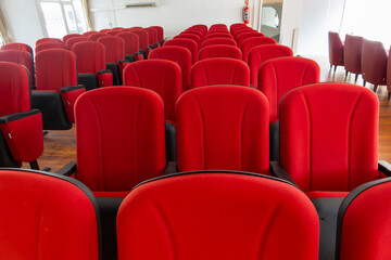 Rows of red chairs in a conference hall