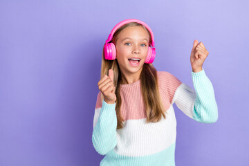 Obraz na płótnie Canvas Photo of overjoyed girl empty space chill catch rhythm audio song melody playlist modern accessory isolated on purple color background