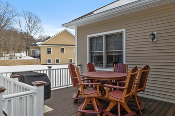 Outdoor reddish poly dining set in a wooden patio on the open air surrounded by houses