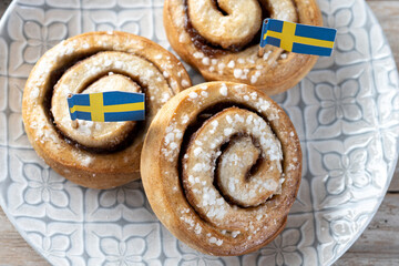 Cinnamon rolls buns on wooden table with copy space. Kanelbulle Swedish dessert