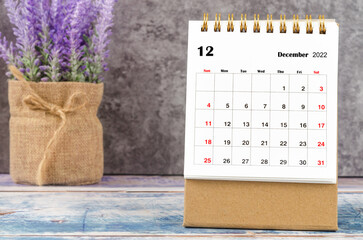 The December 2022 Monthly desk calendar for 2022 year with purple flower.