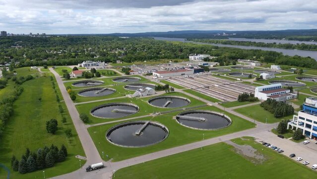 Canadian wastewater sewage plant next to Ottawa River on a cloudy summer day