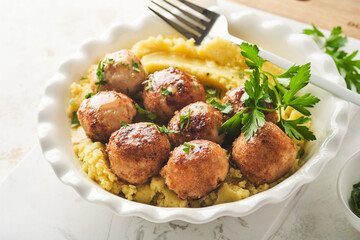 Swedish meatballs in cream sauce, potatoes and lingonberry sauce in bowl on slate, stone or concrete backgrounds. Swedish cuisine. Delicious creamy mashed potatoes. Top view.