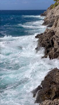 Cephalonia Greek island rocky shore slow motion Ionic sea waves landscape 4K vertical footage. Beauty in nature and traveling concept